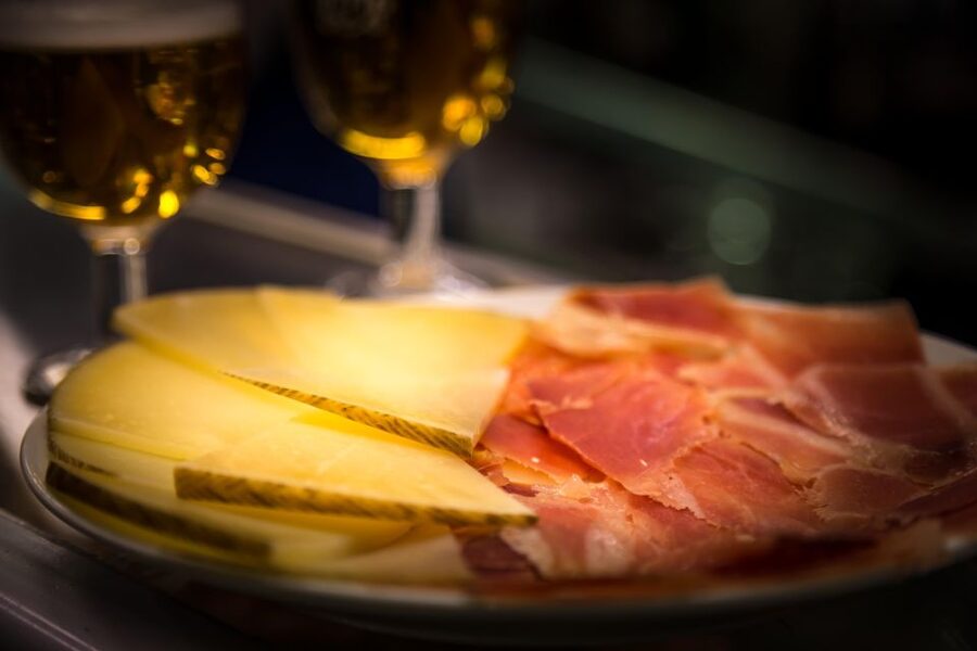 Madrid: Authentic Tapas Evening Tour with a side of History - The first two tapas bars: what you’ll eat and why the standing format matters