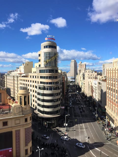 Madrid: Gran Vía Rooftops and Architecture Tour - Metropolis Building and the street-level Gran Vía “power walk”