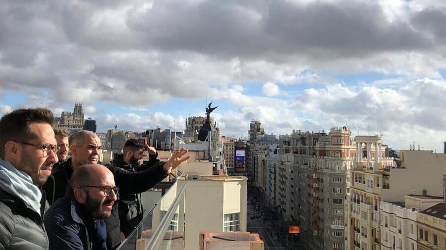 Madrid: Gran Vía Rooftops and Architecture Tour - Plaza de España approach, hotel rooftops, and a view that stretches