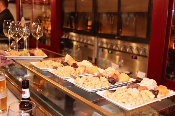 Madrid Small Group Tapas Tour at 4 Venues -Lunch or Dinner - Royal Palace Area and Madrid Old City Hall: The Ham-Focused Stops